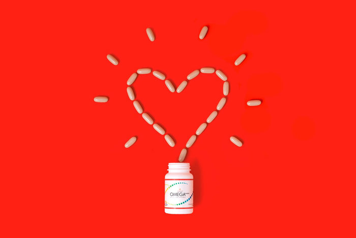 pills forming a heart over a bottle