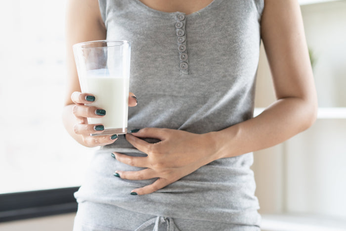 person holding a glass of milk