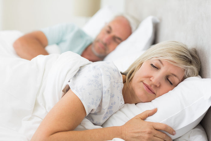 woman sleeping next to a man