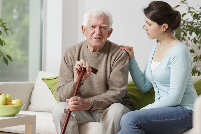 woman holding old mans shoulder