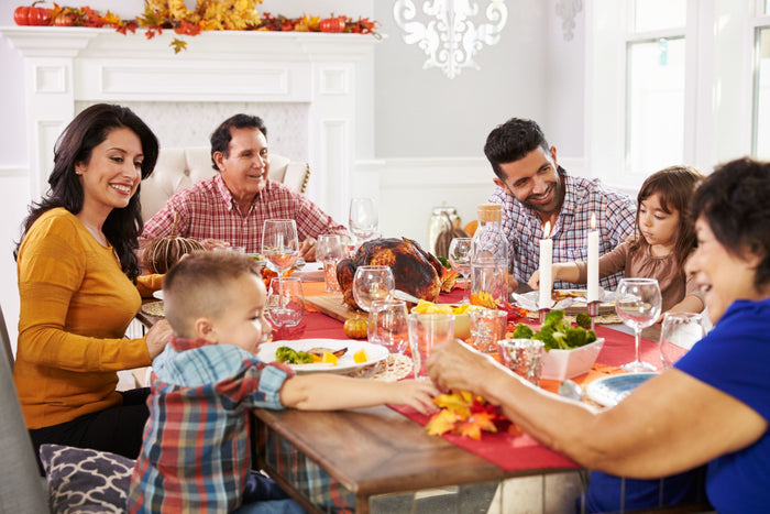 family laughing at thanksgiving table