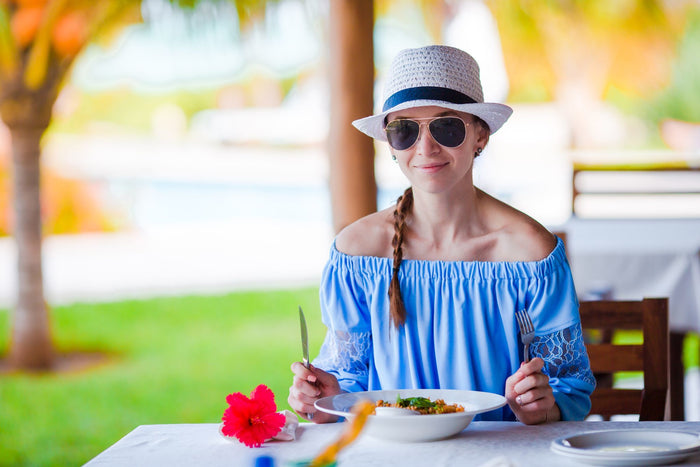 woman eating in the sun