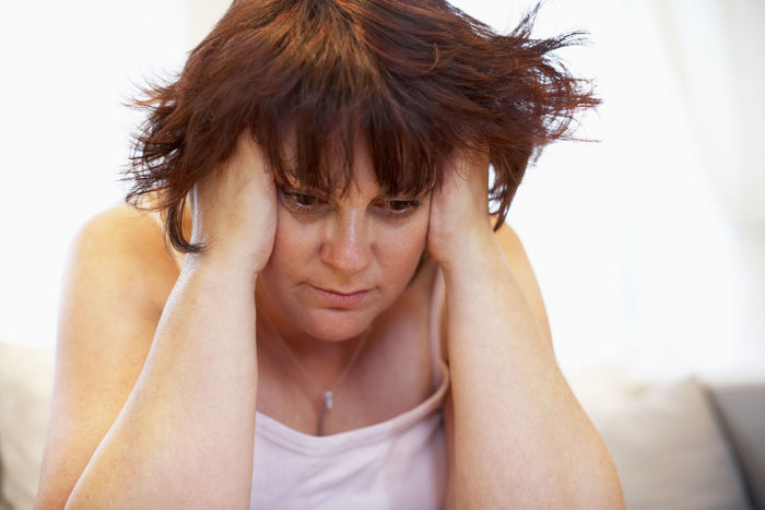 tired woman holding her head