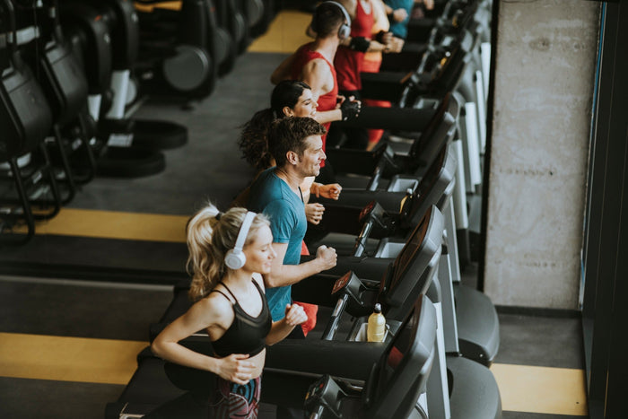 Group of people exercising on treadmills 