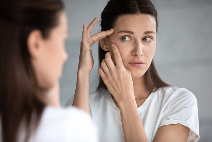 Woman examining her skin